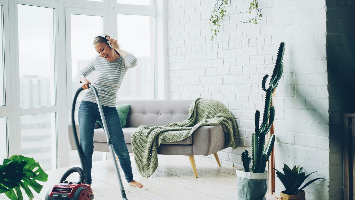Woman vacuuming a bright, modern living room
